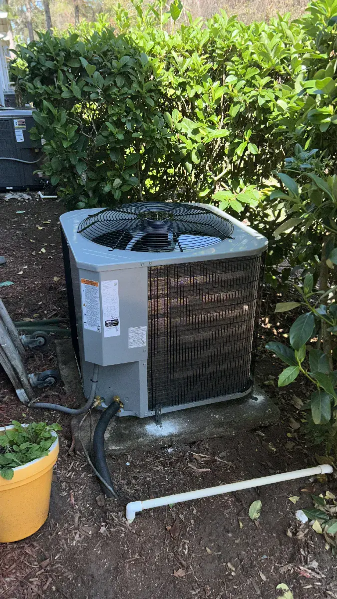 New condenser unit installed alongside landscaping