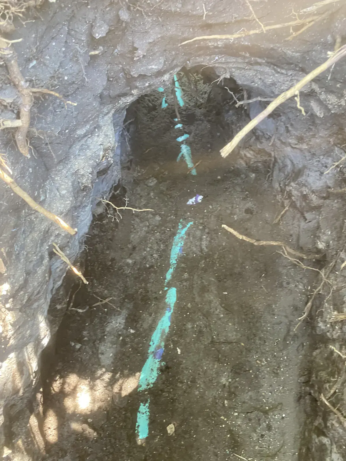 New sewer pipe partly covered with backfill soil in a trench in Neptune Beach, FL