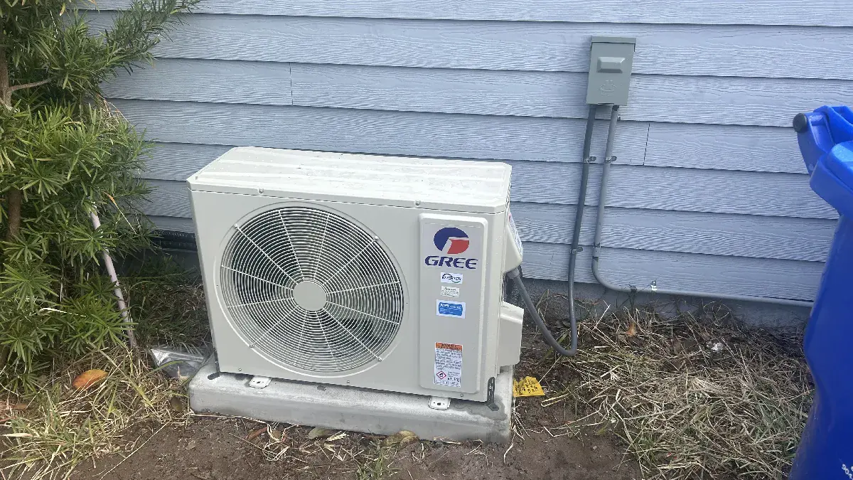 Mini-split outdoor condenser unit installed at a home
